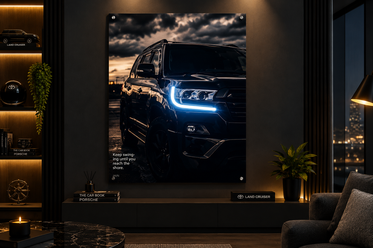 A large vertical wall art print showing a black SUV with glowing blue headlights against a dramatic cloudy sky, displayed in a modern living room setting.