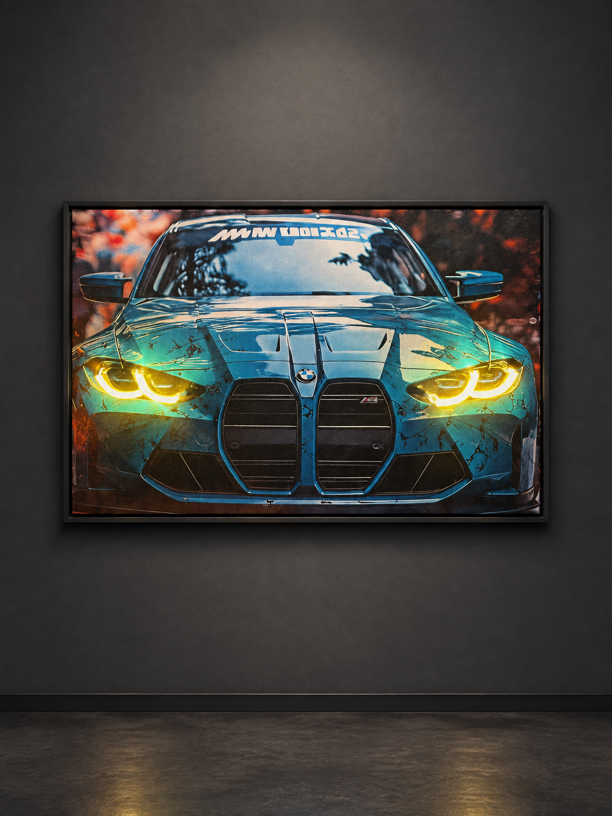 A framed automotive art print of a blue BMW M4 with glowing yellow headlights, displayed on a dark gray wall in a room setting.