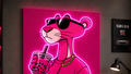 A large canvas wall art print featuring a neon pink cartoon panther wearing sunglasses and holding a boba drink, displayed in a modern gaming room with pink ambient lighting, shelves, a desk, and a chair.