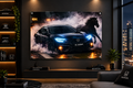 A large wall-mounted framed artwork showing a dark Honda sedan with a horse in a smoky nighttime scene, displayed in a modern living room above a console table. Visible Honda branding appears on decor items and the pillow in the room.