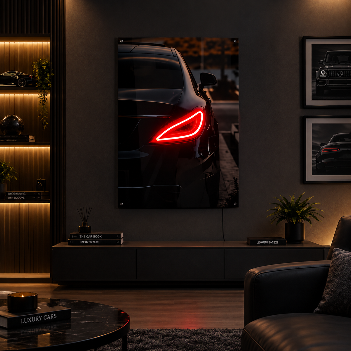 A large vertical wall art print showing a black car with a glowing red taillight, displayed in a modern, dimly lit living room above a low console table.
